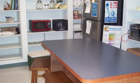 A kitchen with a counter and a microwave on it.